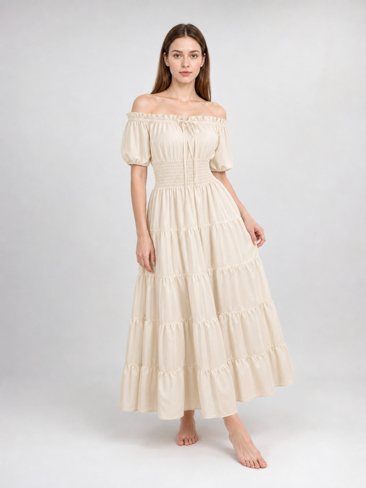 Cream off-shoulder dress with puff sleeves and a gathered waist shown full-body on a model from a slight angle