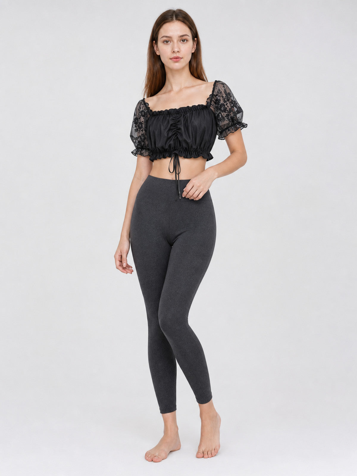 The blouse is black: the main body is made of opaque, smooth fabric