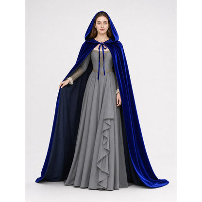 Blue velvet hooded cape worn open over a gray dress, showing the dark lining and front tie on a model