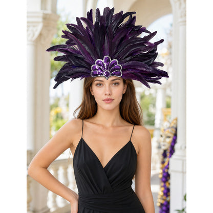 Purple and black feather headpiece with a sparkling central crest, shown on a model wearing a black dress in an indoor setting