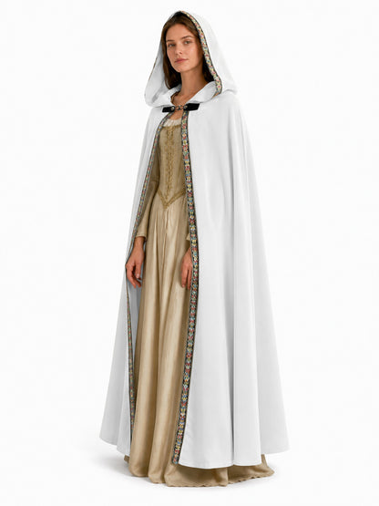 White hooded cape with colorful patterned edging and front clasp, shown full-length on a model against a white background