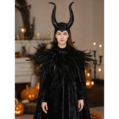 Black horned headpiece and feather-trimmed cape shown on a woman in a candlelit Halloween setting