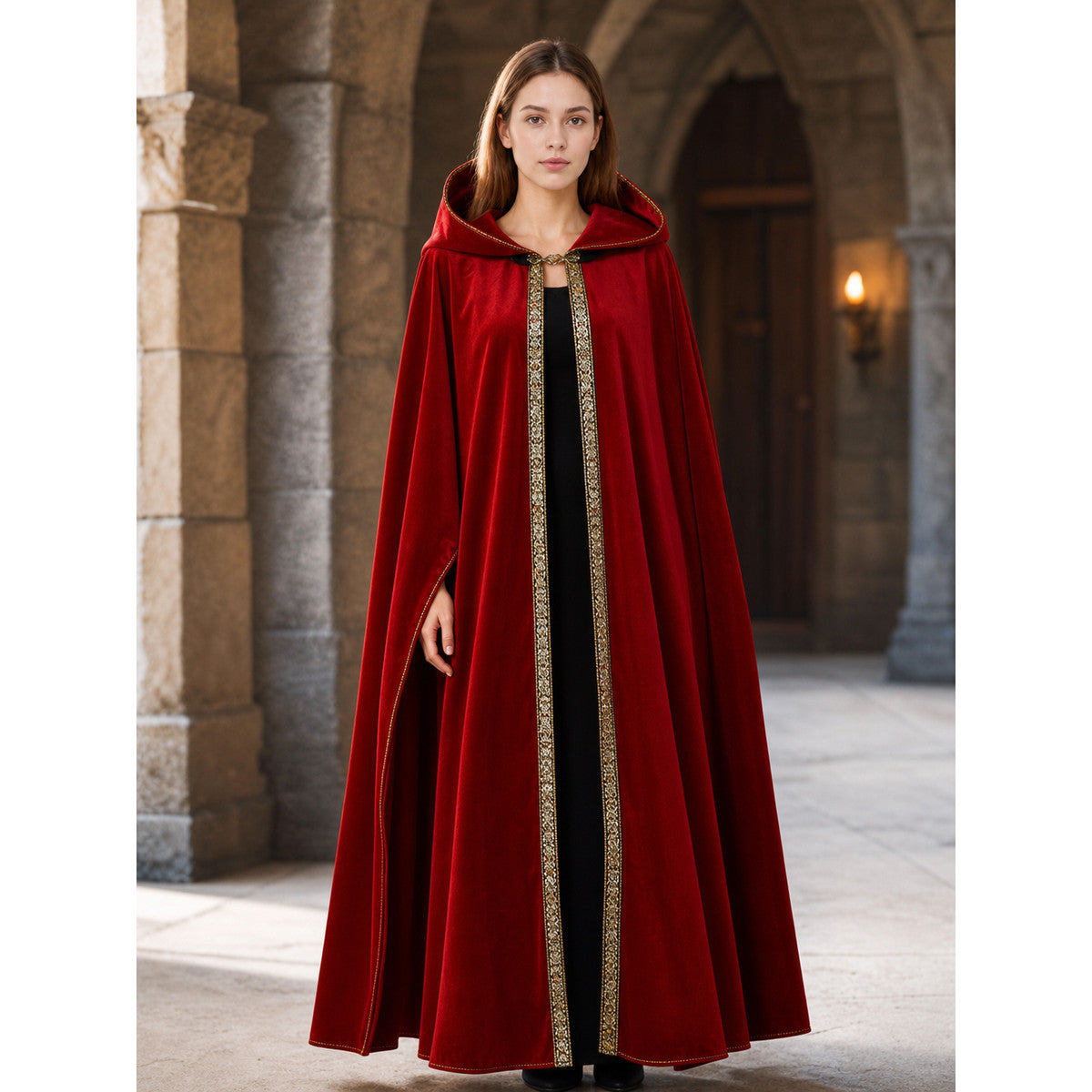 Red hooded cloak shown full-body on a model in a stone archway, with a flowing open front and patterned vertical trim