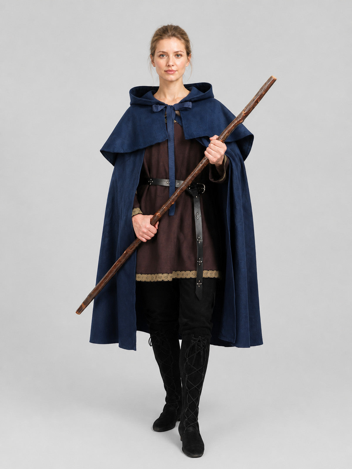 Navy blue hooded cape with layered shoulder capelet, shown full-body on a model holding a wooden staff