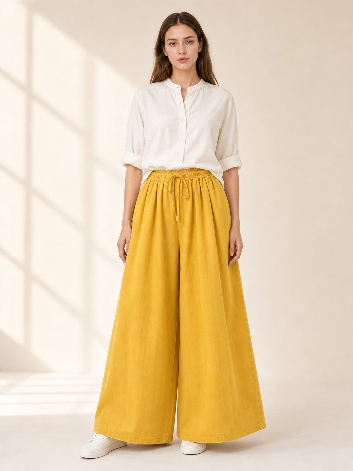Mustard-colored wide-leg pants with long pant legs lifestyle view