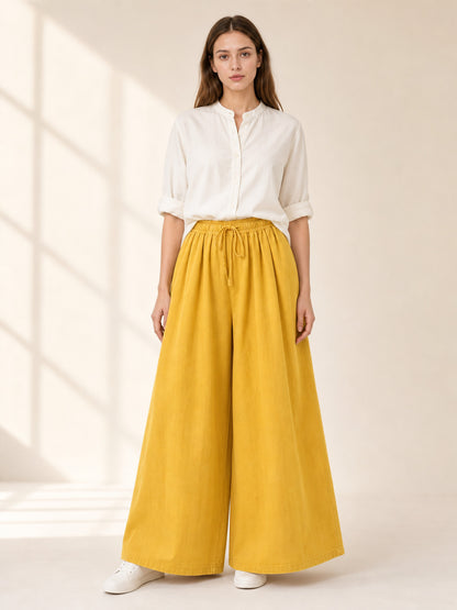 Mustard-colored wide-leg pants with long pant legs lifestyle view