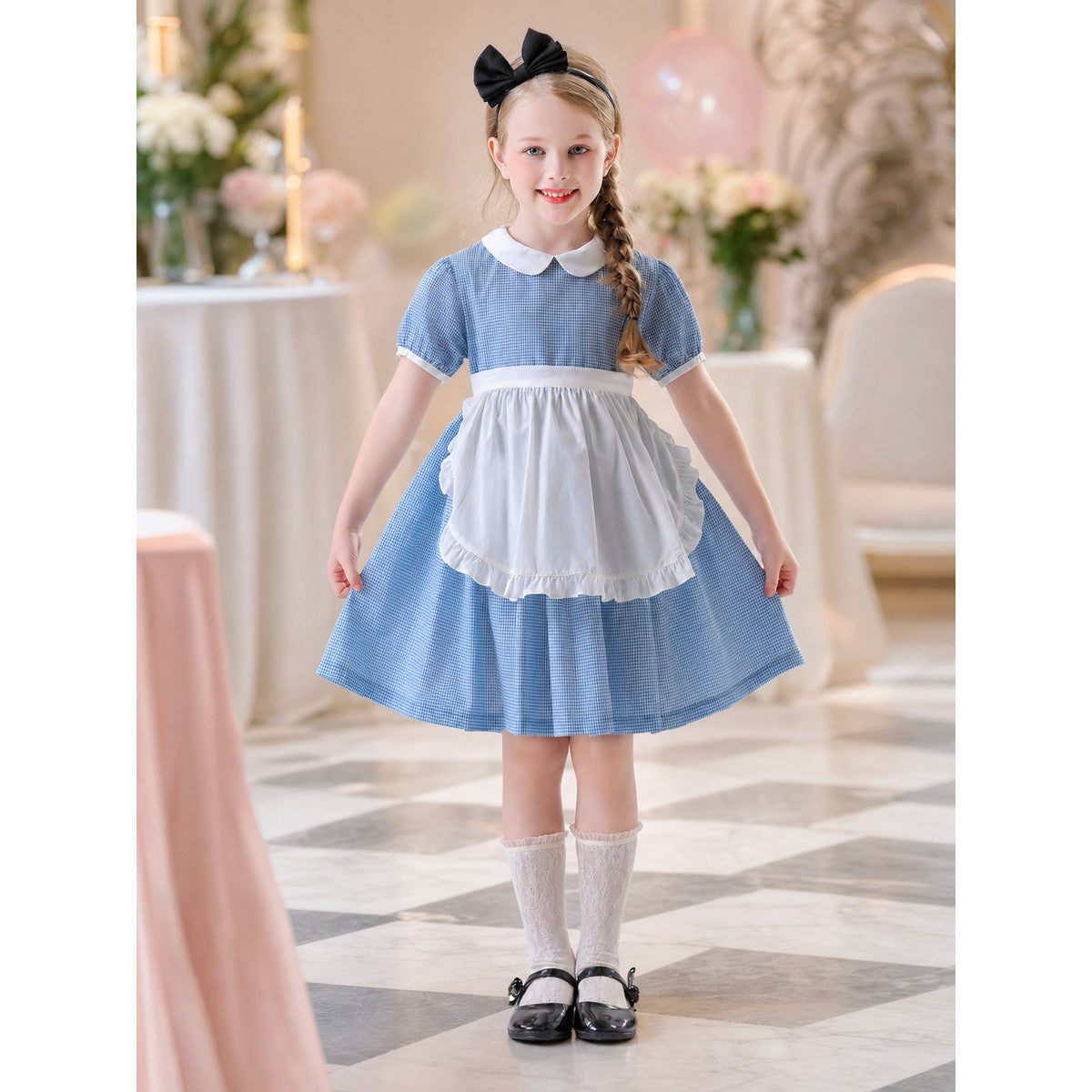 The dress is designed in a retro style, combining a blue-and-white small check pattern with distinctive white details. A white apron-like insert is featured on the front, while the white Peter Pan collar and white waist detail reinforce the