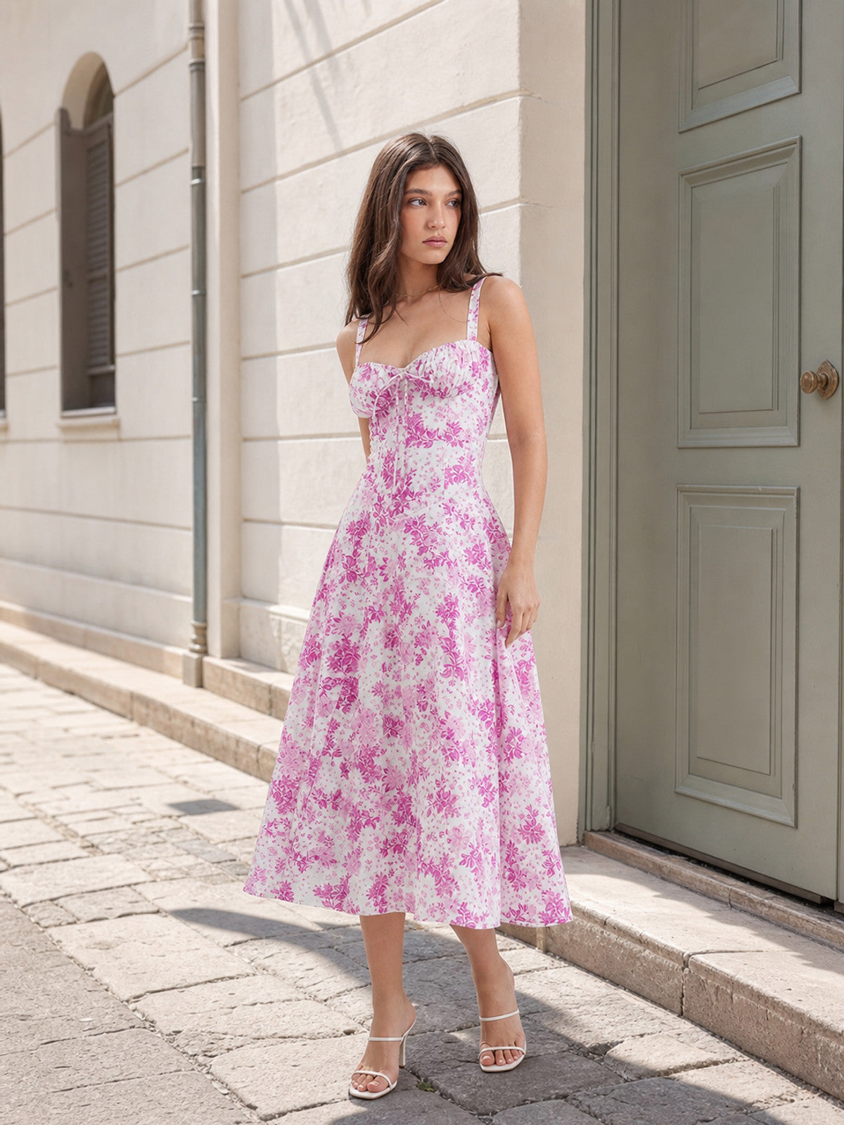 The design features a midi dress with thin straps and a square neckline. The