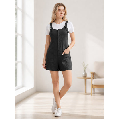 Black textured bib shorts with front buttons and pockets, modeled with a white T-shirt in a bright indoor setting