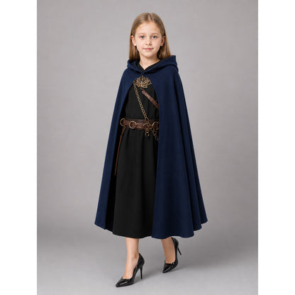 Dark blue hooded cloak shown full-body on a girl, worn open over a black dress with a long flared hem