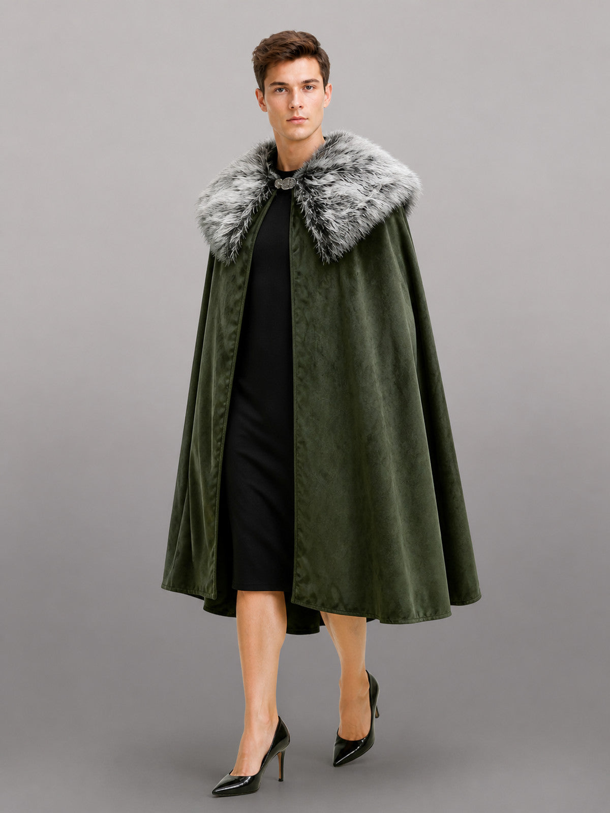 Dark olive cape in velvet-look fabric with a wide gray faux fur collar, shown full-length on a model