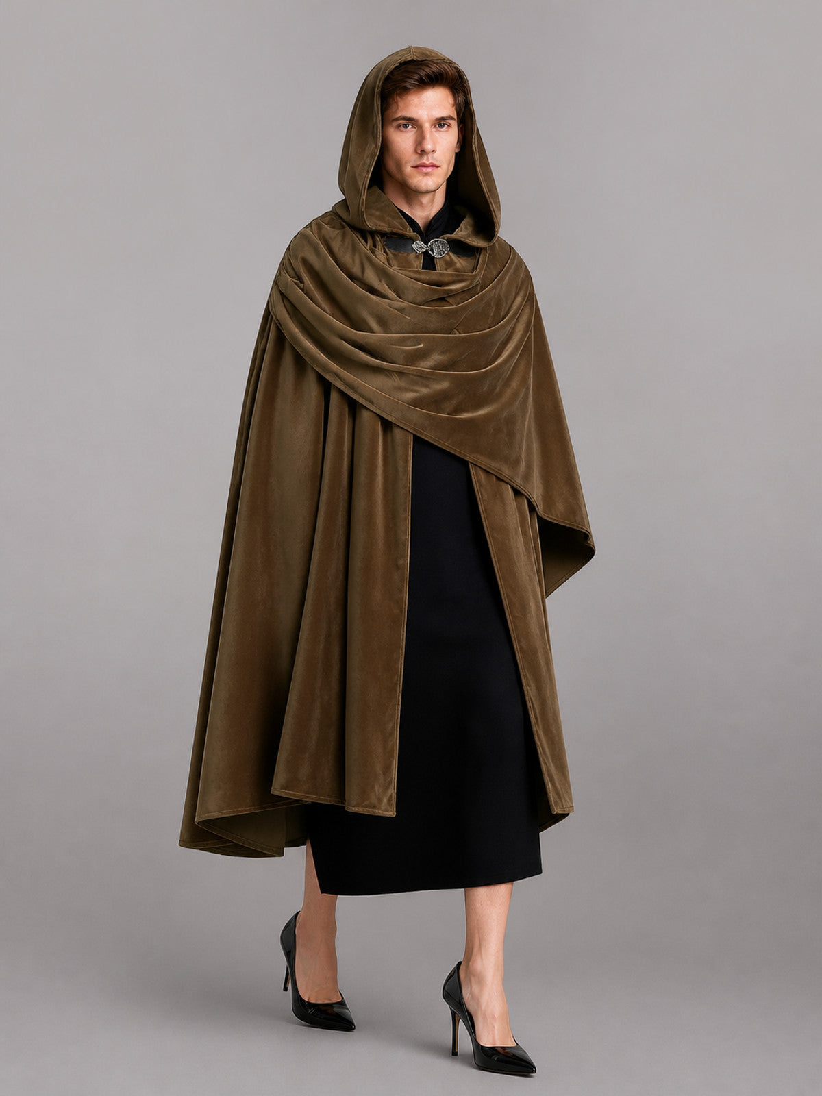 Brown velvet-look hooded cloak shown full-length on a model, with the hood raised, layered draping, and a front clasp