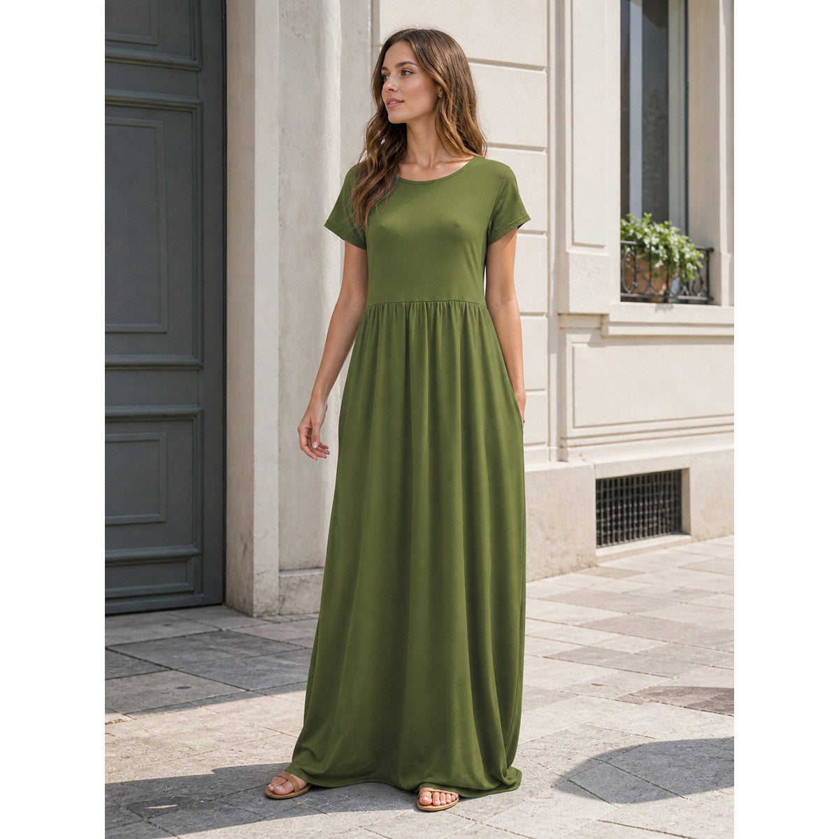Everyday women's dress with a round neckline, short sleeves, and a long skirt. The dress is olive, or army green, in color. The top has a round neckline and short sleeves, while the waist features gathers that connect the bodice to the long
