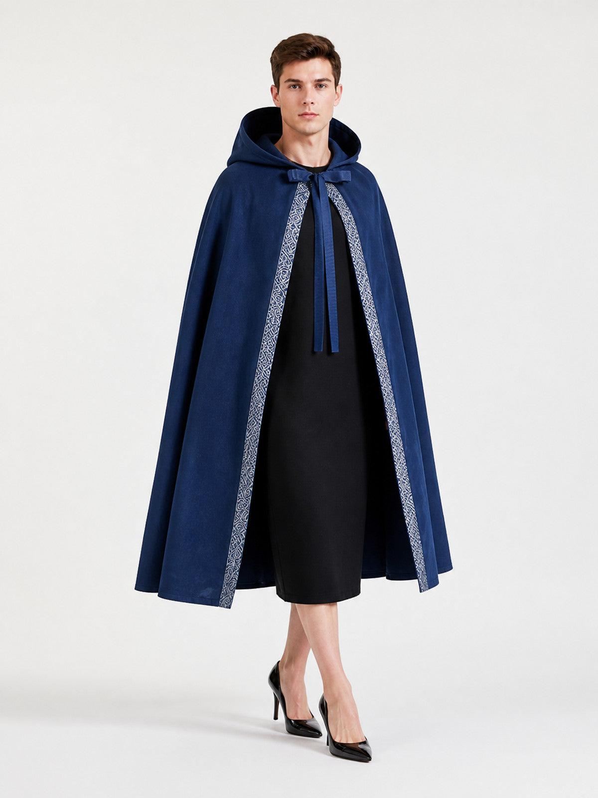 Blue hooded cloak shown full-body on a model, featuring a front tie and contrasting patterned trim