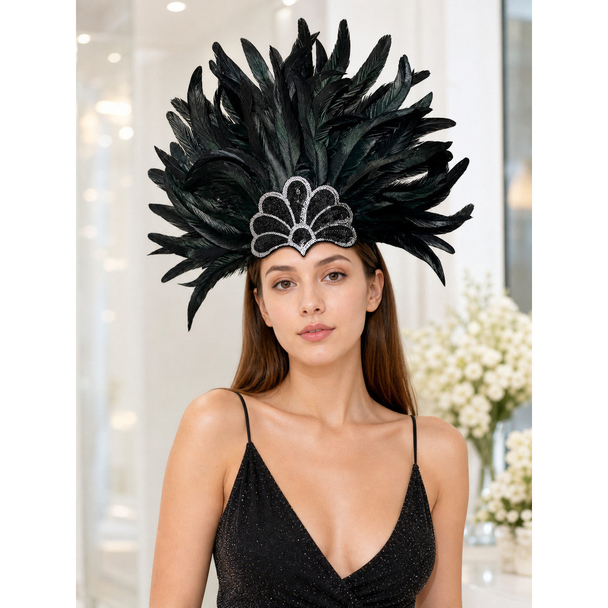 Feather headpiece in black with tall layered plumes and a scalloped embellished front, shown on a model in a styled interior