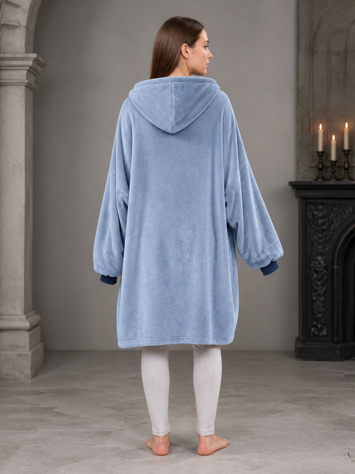 This hooded long coat features a sky blue body with navy patchwork front panels