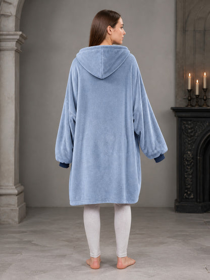 This hooded long coat features a sky blue body with navy patchwork front panels