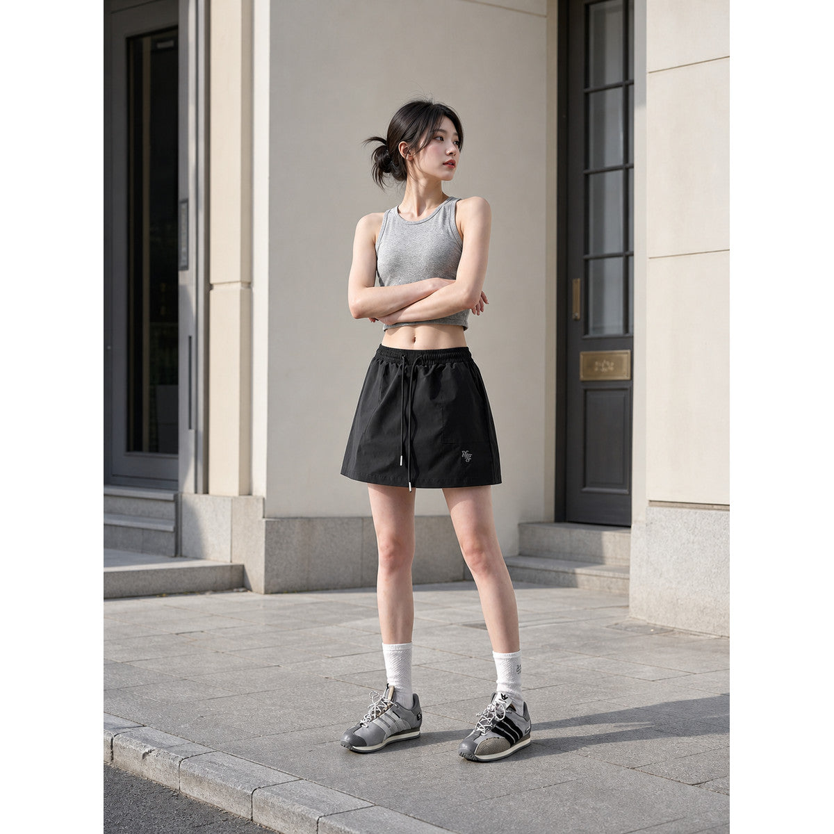 Loose-fit women's shorts with an elastic waistband and drawstring. The design features a minimalist style and a noticeable detail at the front—a drawstring for adjustment. The elastic waistband helps maintain a neat fit, while the loose cut
