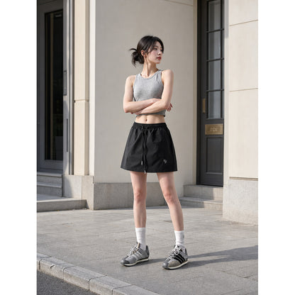 Loose-fit women's shorts with an elastic waistband and drawstring. The design features a minimalist style and a noticeable detail at the front—a drawstring for adjustment. The elastic waistband helps maintain a neat fit, while the loose cut