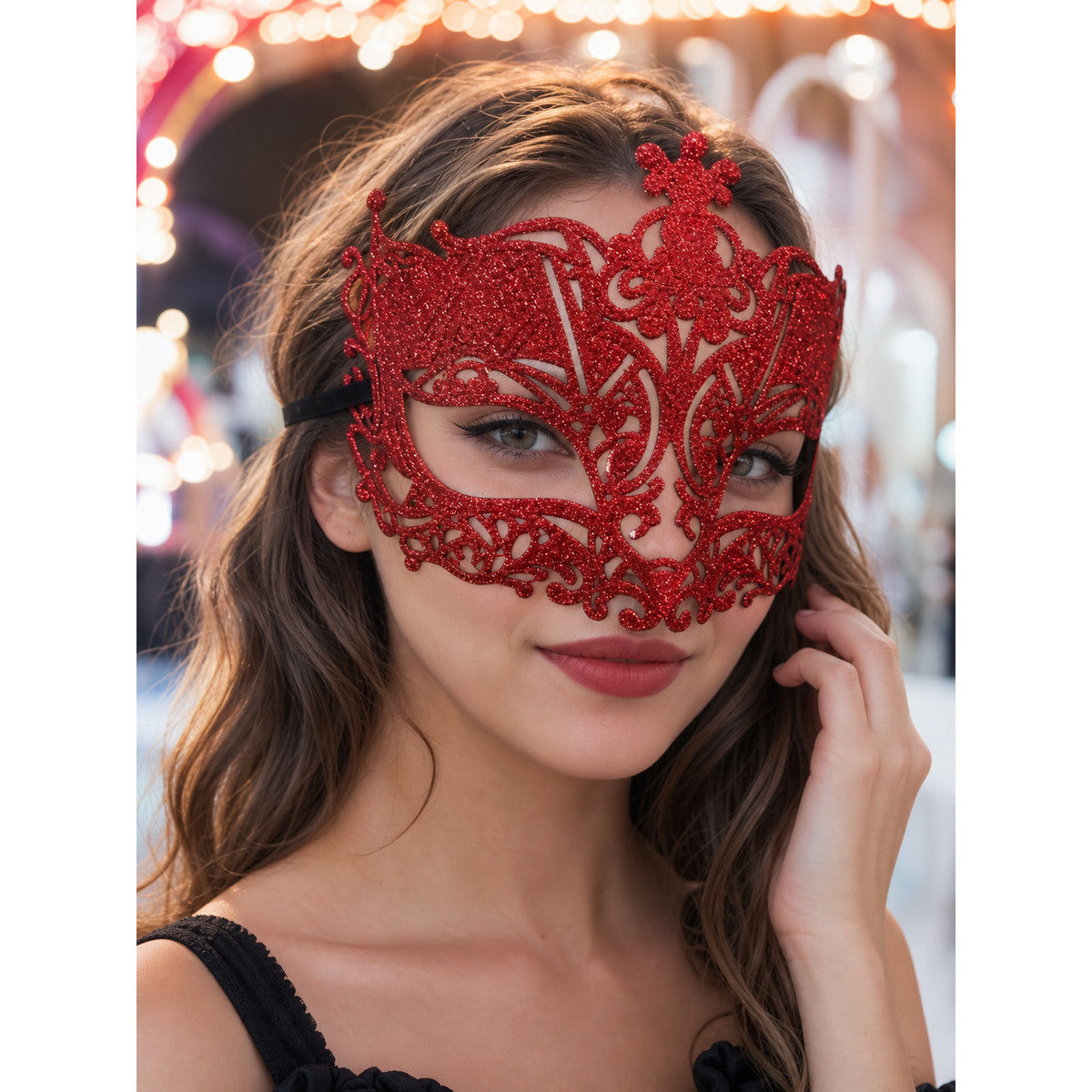 Red glitter filigree masquerade mask with black ribbon worn by a woman in a festive setting