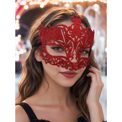 Red glitter filigree masquerade mask with black ribbon worn by a woman in a festive setting