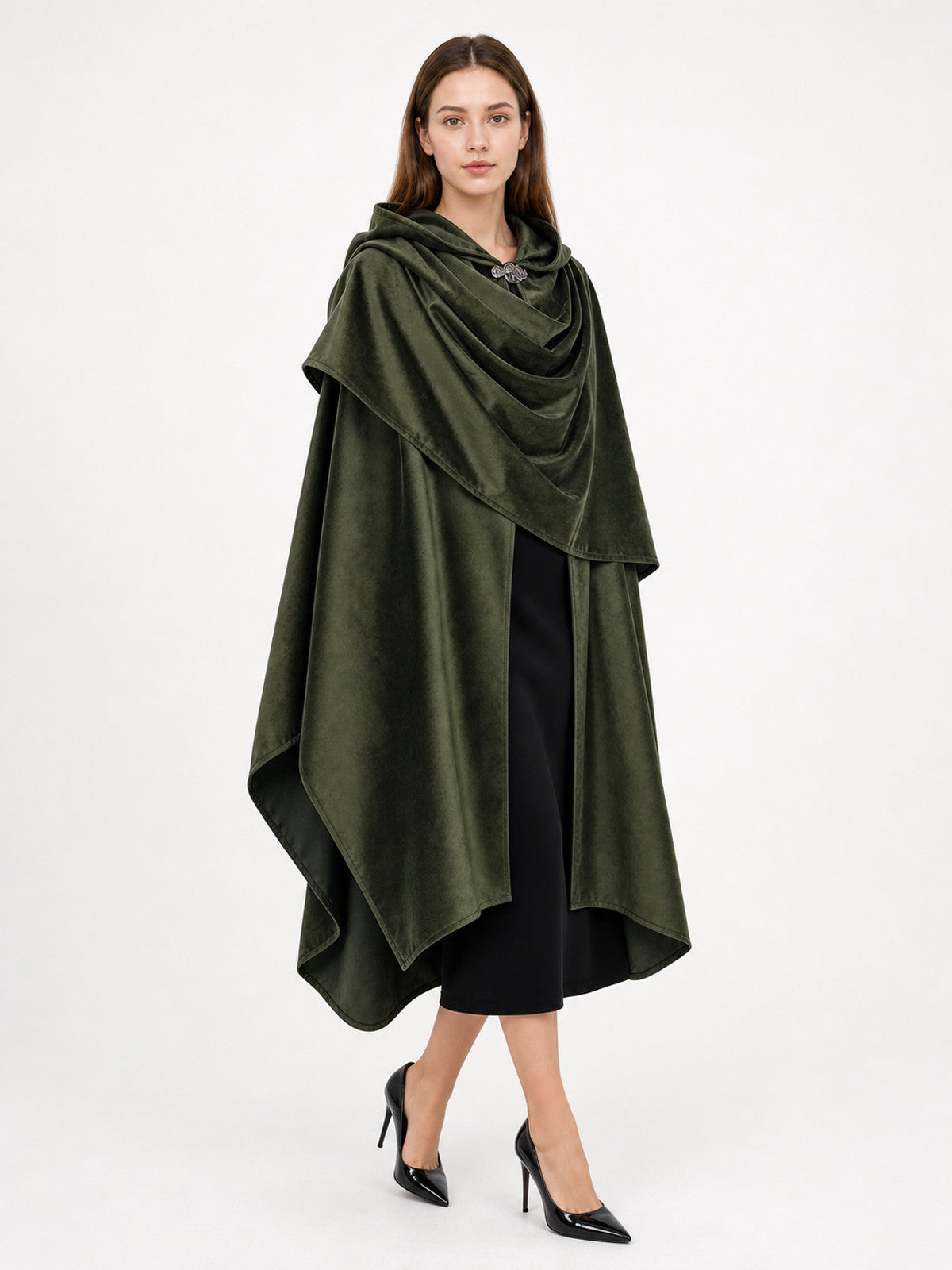 Dark green velvet-look hooded cloak modeled against a white background, showing layered draping, an asymmetrical hem, and silver clasp