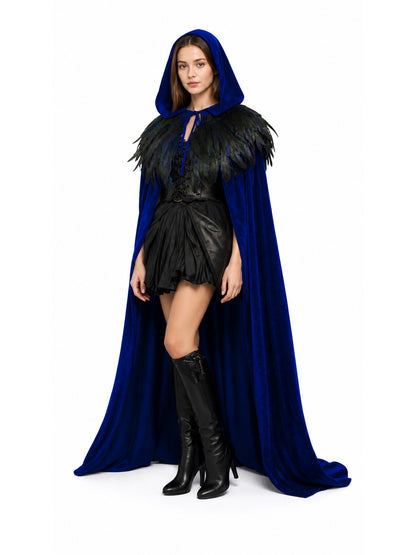 Blue hooded cape with black feather shoulder trim, shown on a model in a three-quarter full-body pose