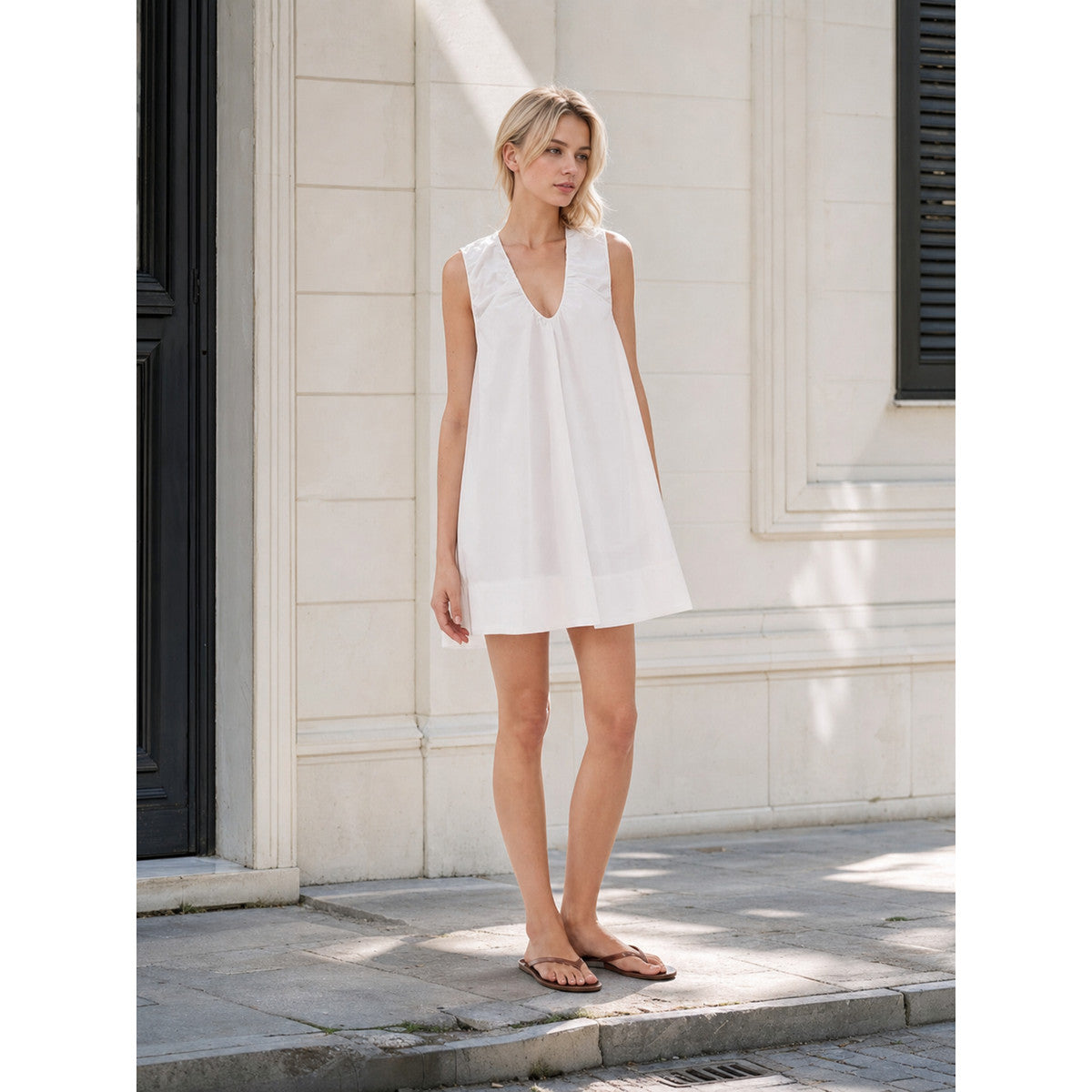 White Sleeveless Dress with a V-Neck and Loose A-Line Silhouette