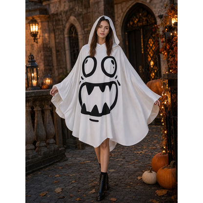 White hooded ghost poncho with a black face graphic and extended draped sleeves, modeled on a decorated stone walkway