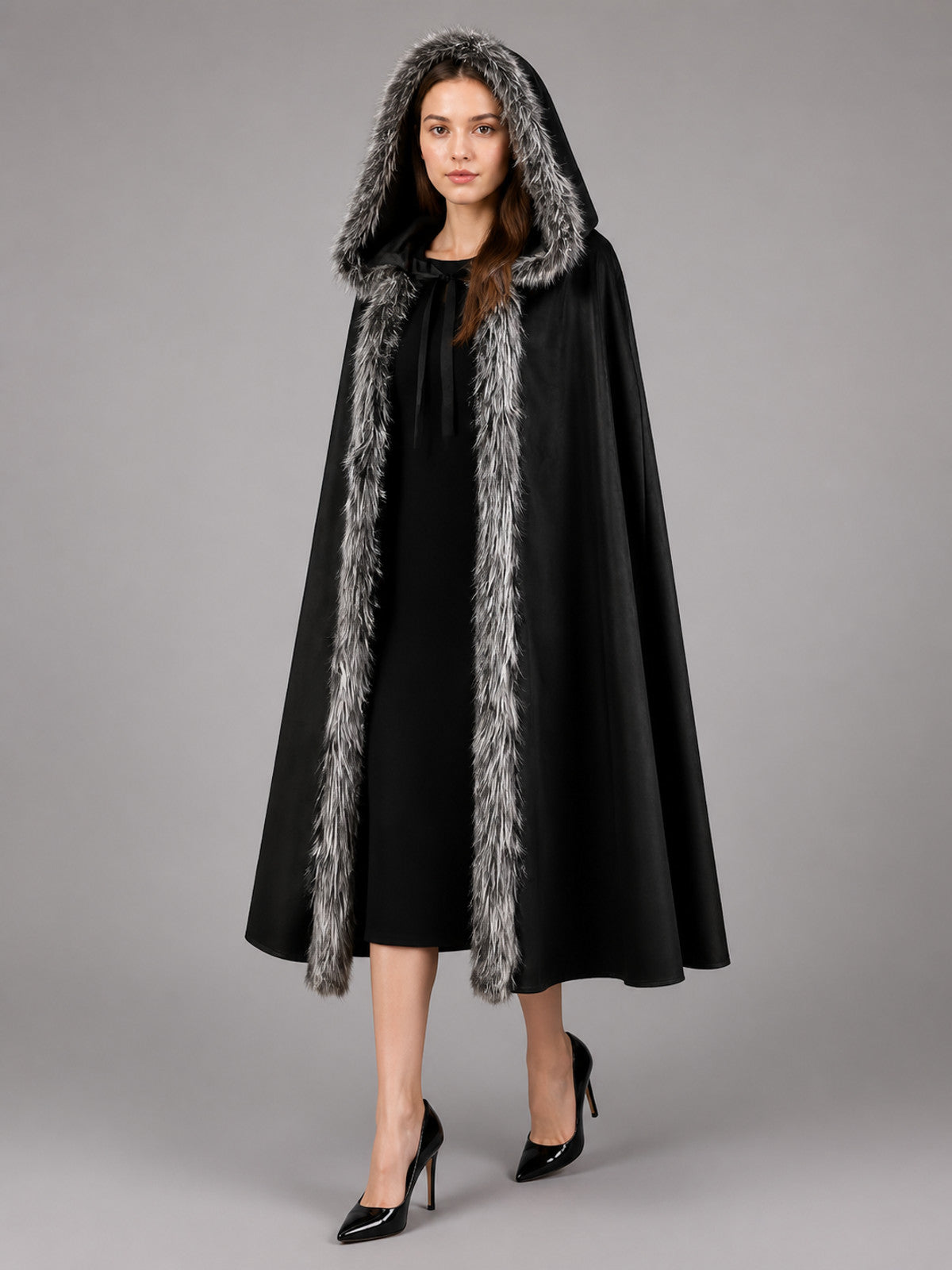 Black hooded cloak with gray faux-fur edging, shown front-facing on a model in a gray studio