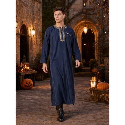 Navy blue long robe on a walking model in a lantern-lit stone courtyard, with embroidered neckline trim and black boots