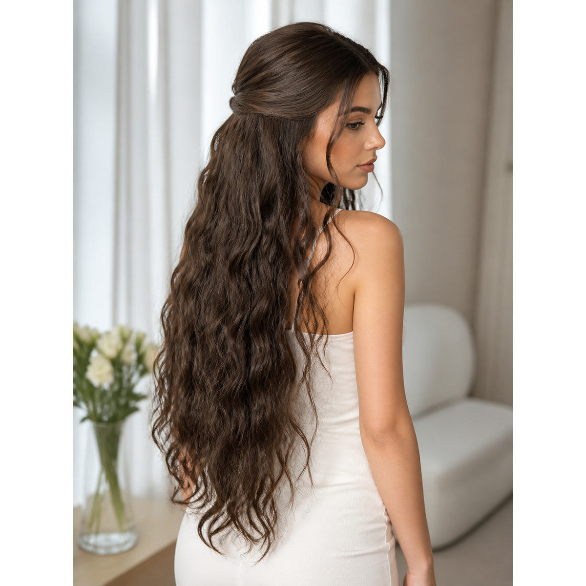 Long brown wavy costume beard shown from behind on a woman in a white dress, extending to the middle of her back