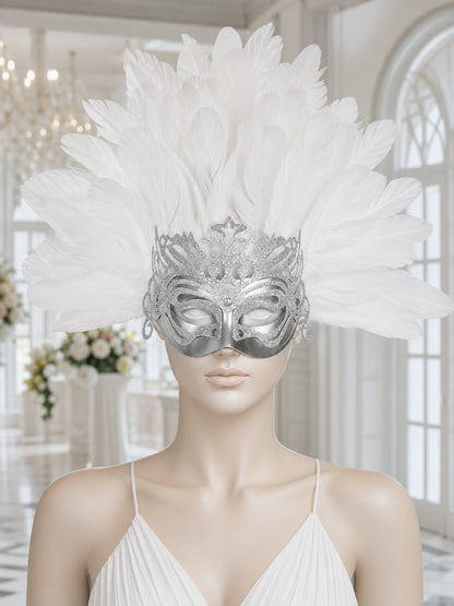Silver eye mask with a large white feather plume displayed on a mannequin in a bright interior