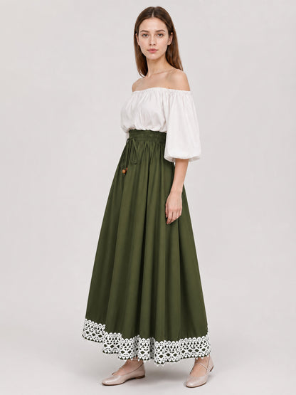 Full-body side view of an olive green maxi dress with a flowing skirt, white off-shoulder bodice, gathered waist, and lace-trimmed hem