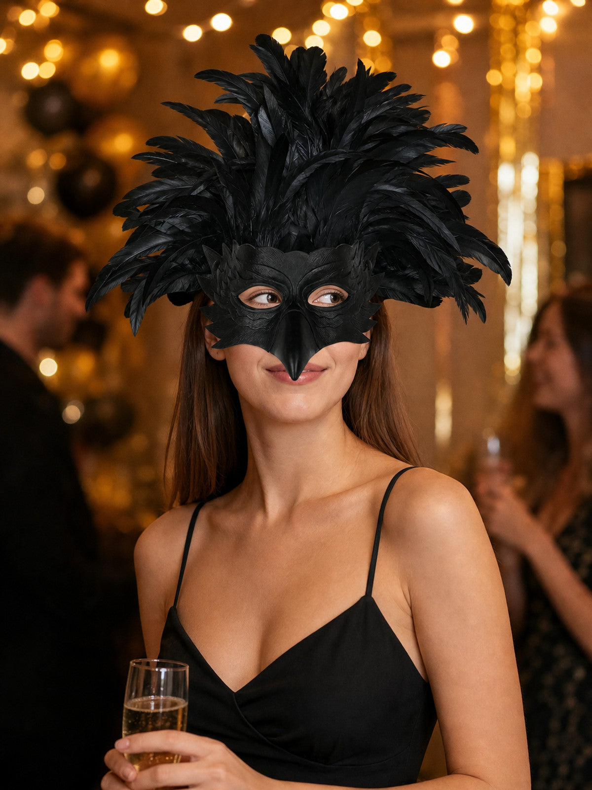 Black feathered bird mask worn by a woman in a black dress at a decorated evening event