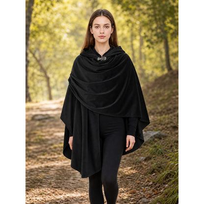 Black hooded cloak with layered draping and front clasp, shown on a model in a wooded outdoor setting