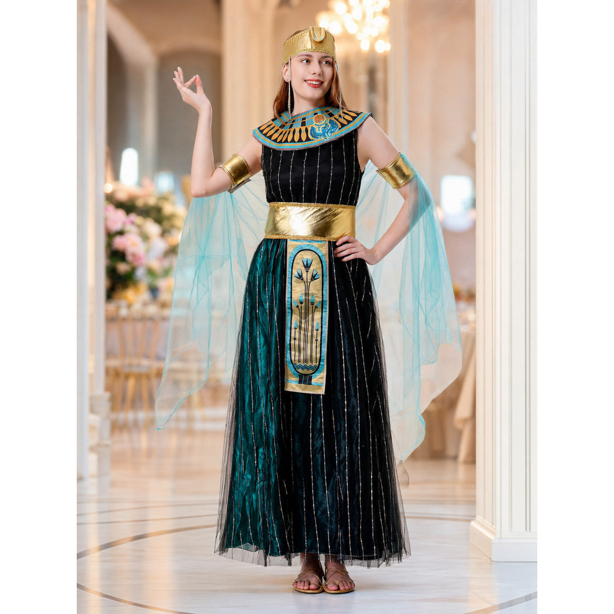 Cleopatra costume designed in an Egyptian-inspired style and decorated in a combination of black, gold, light blue, and blue-green colors. The outfit is centered around a black dress with a skirt and fitted upper section. Vertical sequin st