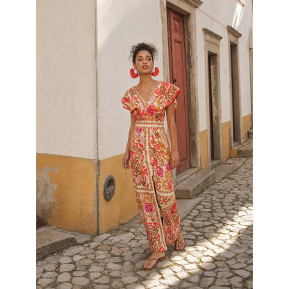 One-piece jumpsuit with a V-neckline, short sleeves, and wide-leg pants. The design is made as a single construction with a connection at the waistline. The upper part features a V-neckline and short sleeves, while decorative patterned elem