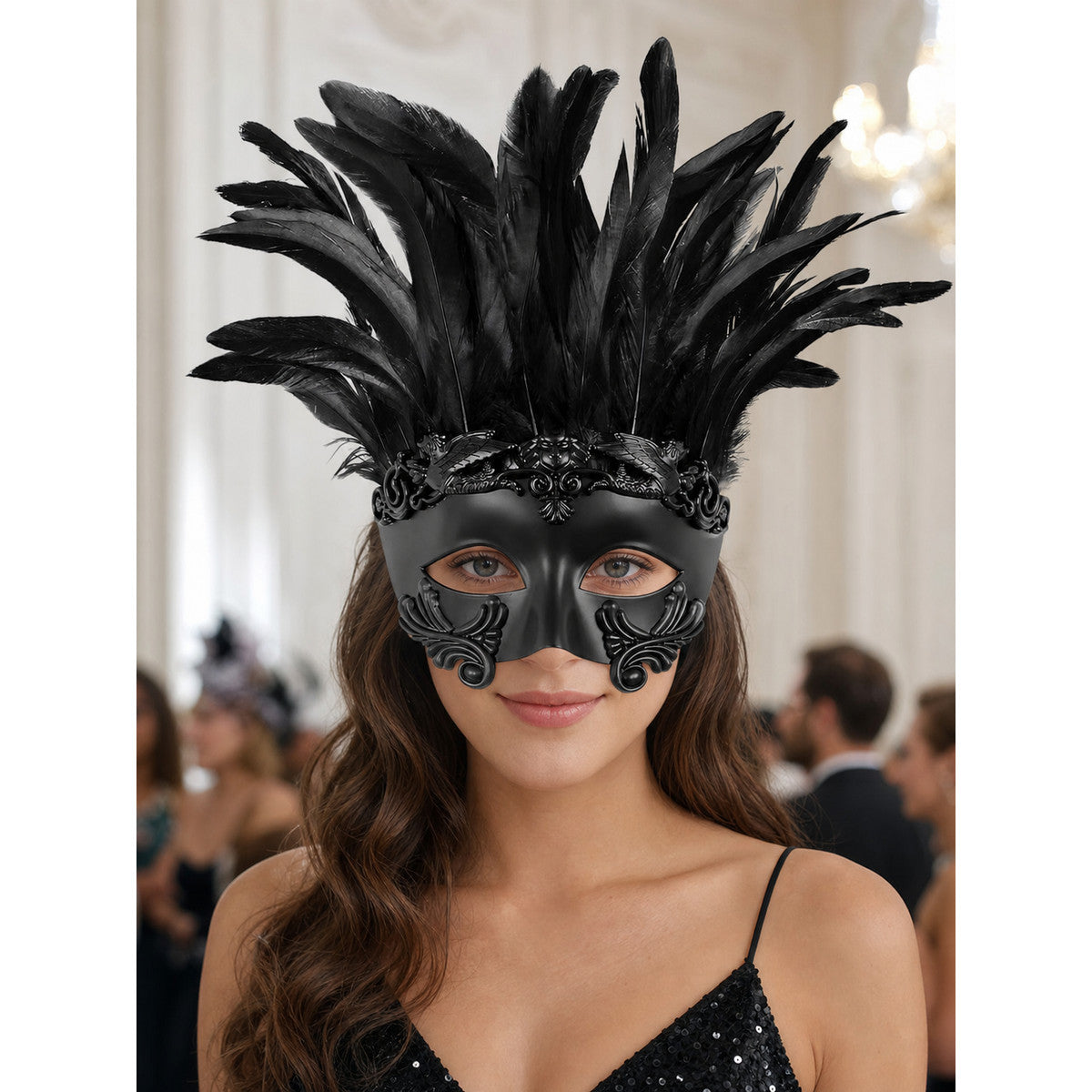 Black feather masquerade mask with raised decorative scrollwork shown on a woman in a formal indoor setting