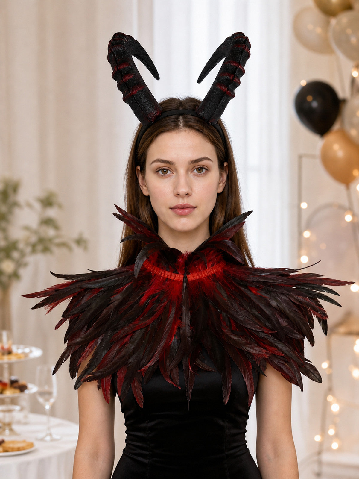 Black and red horned headpiece and layered feather collar shown on a model in a festive indoor setting