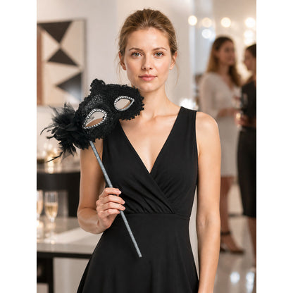 Carnival mask with black lace and feathers on a stick lifestyle view