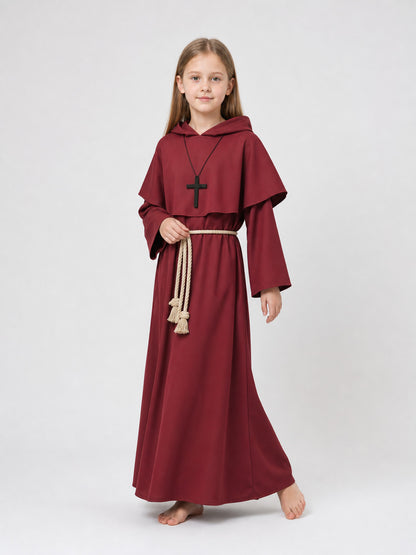Full-body child model wearing a burgundy robe with a draped hood, black cross pendant, and cream rope belt