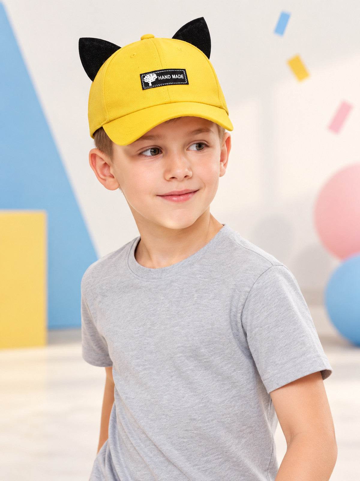 Yellow baseball cap with black ears and patch