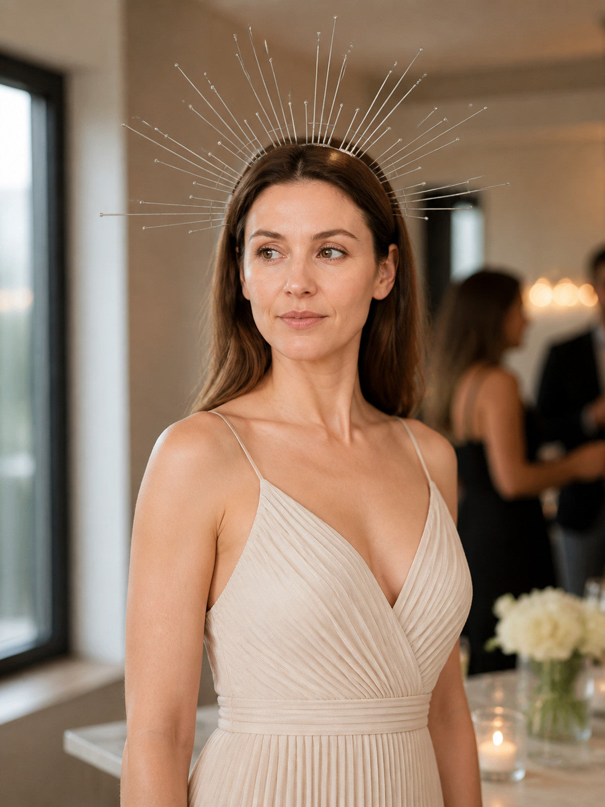 Silver halo headpiece with fine bead-tipped wires worn by a model in a styled indoor scene