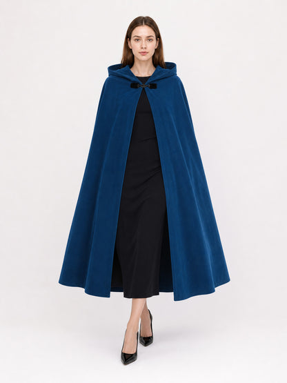 Blue hooded cloak with black clasp, shown full-body on a model with the hood resting behind her neck