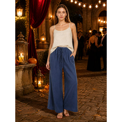 Navy wide-leg pants with a gathered drawstring waist and side pockets, shown full-body on a model outdoors