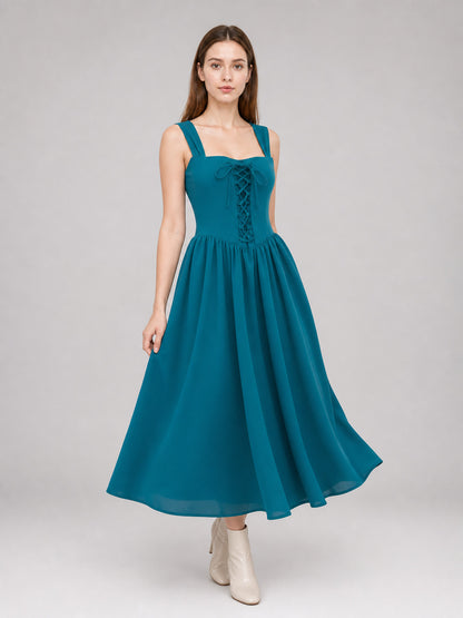 Teal sleeveless dress with a lace-up bodice and flowing full skirt shown on a model in a three-quarter pose