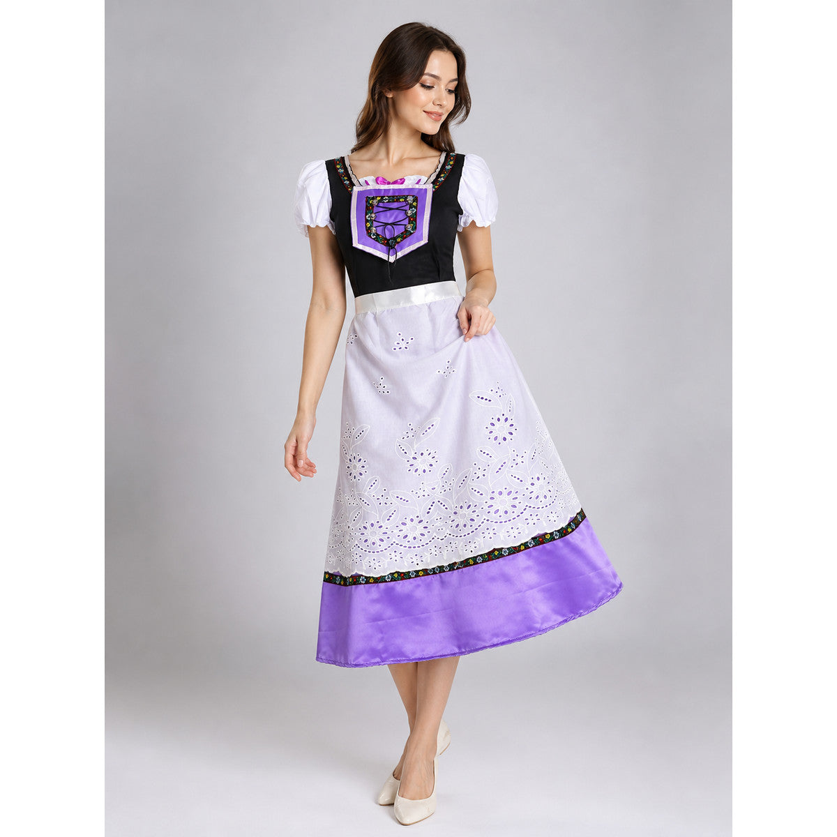 The dress is designed in an ethnic style and features a contrasting combination of white, pink, purple, and black. It has a black bodice, voluminous white puff sleeves, and a white waistband. The front is decorated with a purple lace-up det