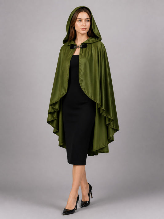 Green satin-look hooded cloak with layered pointed edges and front clasp, shown full-body on a model against a gray background