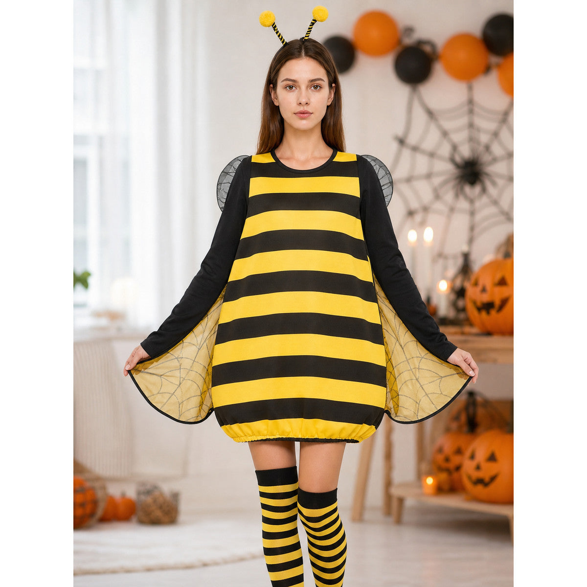 Full-body view of a black and yellow striped costume with antennae and translucent wings in a Halloween-decorated room